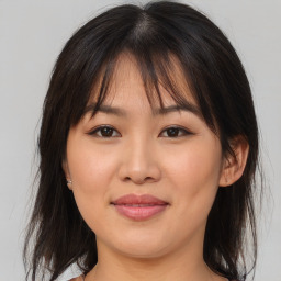 Joyful asian young-adult female with medium  brown hair and brown eyes