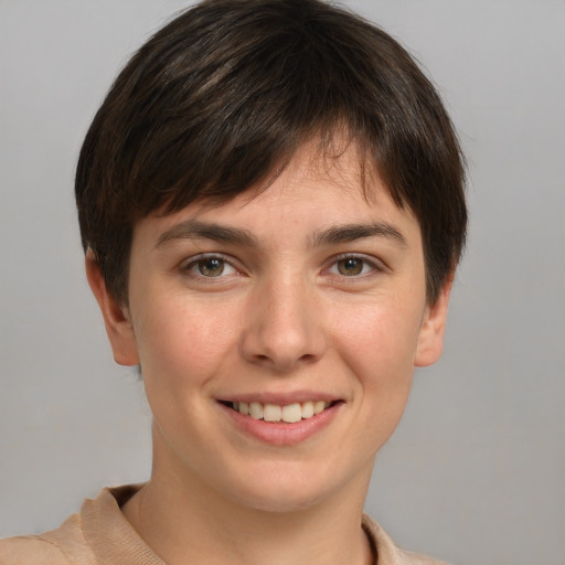 Joyful white young-adult female with short  brown hair and grey eyes