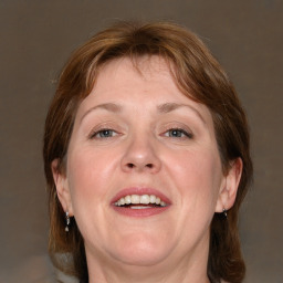 Joyful white adult female with medium  brown hair and grey eyes