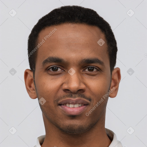 Joyful black young-adult male with short  black hair and brown eyes