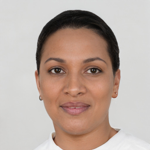 Joyful latino young-adult female with short  black hair and brown eyes
