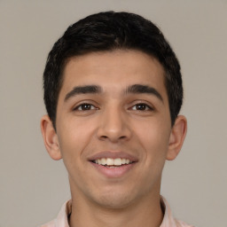 Joyful latino young-adult male with short  black hair and brown eyes