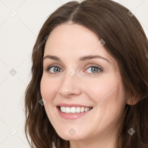 Joyful white young-adult female with long  brown hair and green eyes