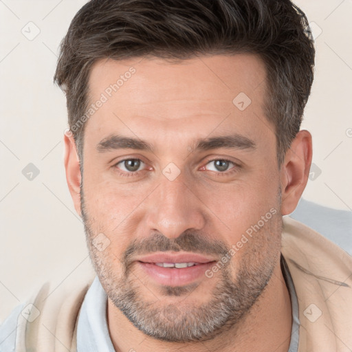 Joyful white young-adult male with short  brown hair and brown eyes