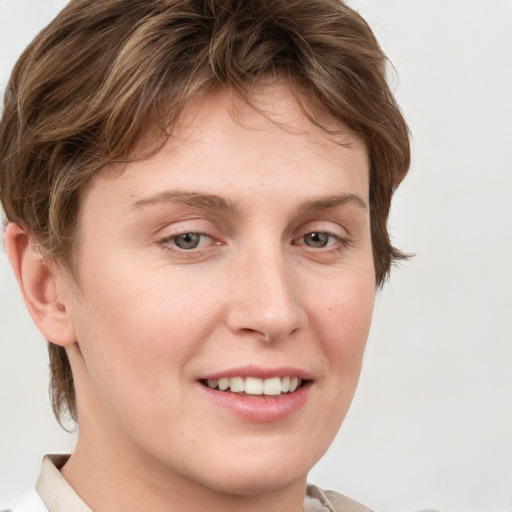 Joyful white young-adult female with short  brown hair and grey eyes