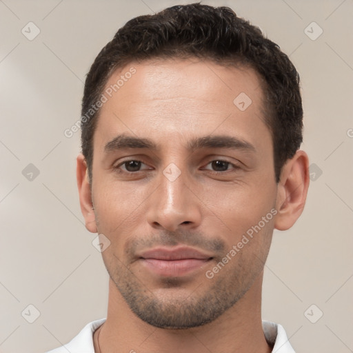 Joyful white young-adult male with short  black hair and brown eyes