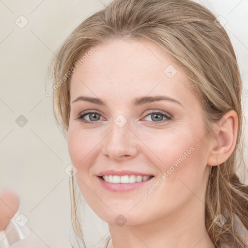 Joyful white young-adult female with medium  brown hair and blue eyes