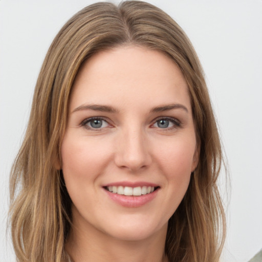 Joyful white young-adult female with medium  brown hair and green eyes