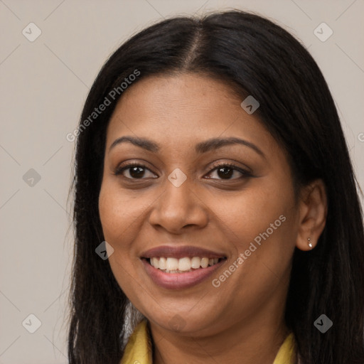 Joyful black young-adult female with long  brown hair and brown eyes