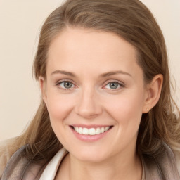 Joyful white young-adult female with long  brown hair and blue eyes