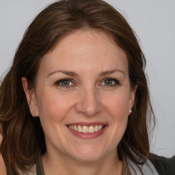 Joyful white adult female with medium  brown hair and grey eyes