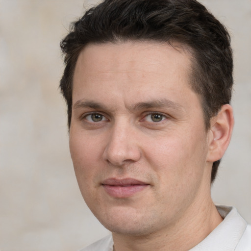 Joyful white adult male with short  brown hair and brown eyes