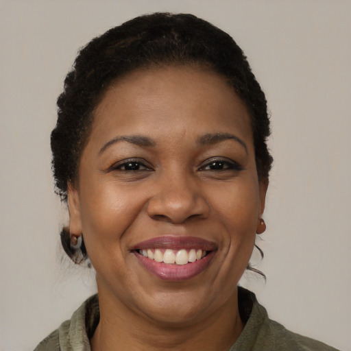 Joyful black adult female with short  brown hair and brown eyes