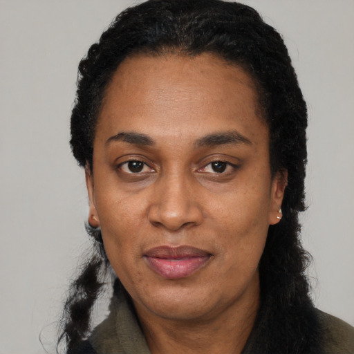 Joyful black adult female with short  black hair and brown eyes