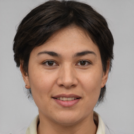 Joyful asian adult female with medium  brown hair and brown eyes
