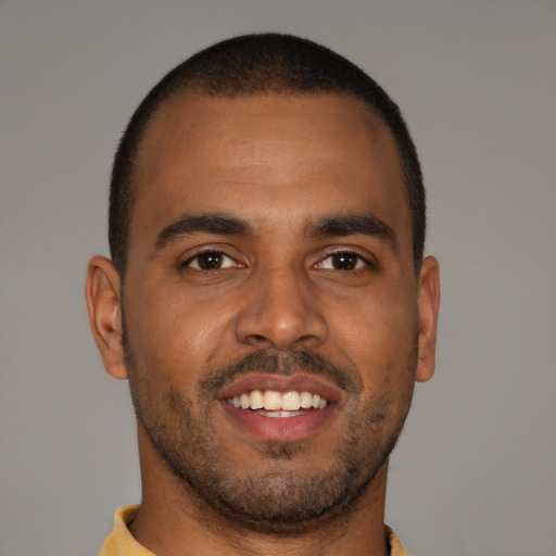Joyful black young-adult male with short  brown hair and brown eyes