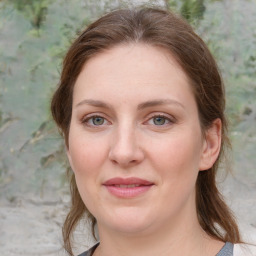 Joyful white young-adult female with medium  brown hair and green eyes