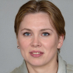 Joyful white young-adult female with medium  brown hair and blue eyes