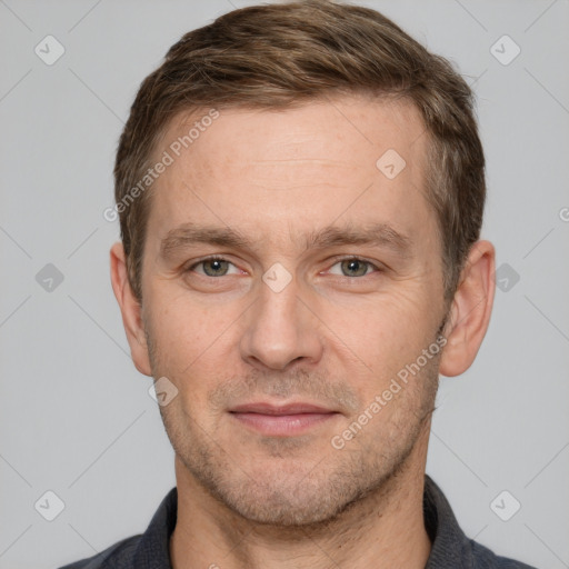 Joyful white adult male with short  brown hair and grey eyes