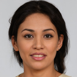 Joyful latino young-adult female with medium  brown hair and brown eyes