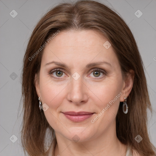 Joyful white adult female with long  brown hair and grey eyes