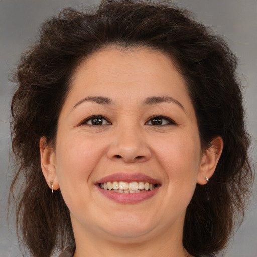 Joyful white adult female with medium  brown hair and brown eyes