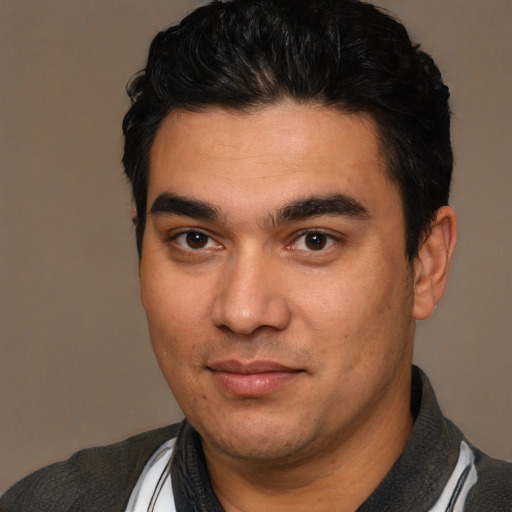 Joyful white young-adult male with short  black hair and brown eyes