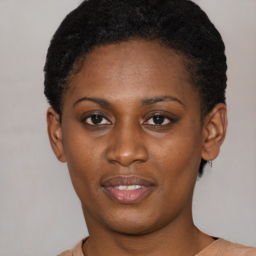 Joyful black young-adult female with short  black hair and brown eyes