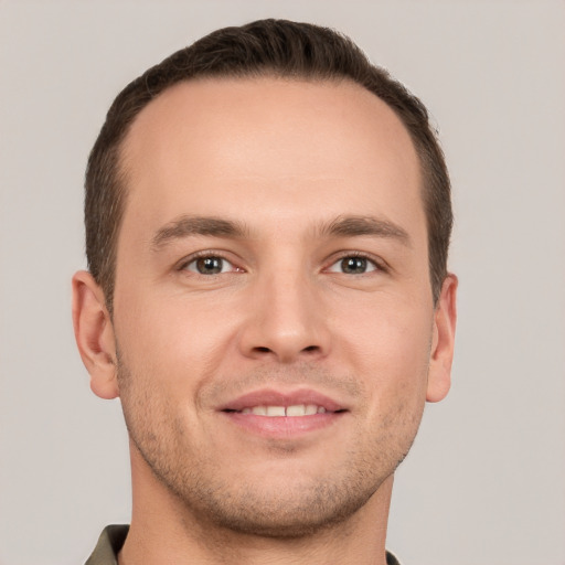 Joyful white young-adult male with short  brown hair and grey eyes