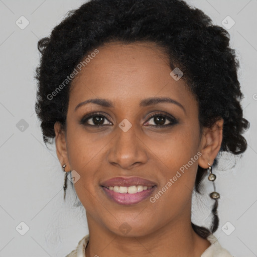 Joyful black young-adult female with long  brown hair and brown eyes