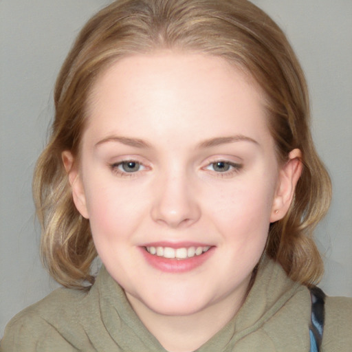 Joyful white young-adult female with medium  brown hair and blue eyes