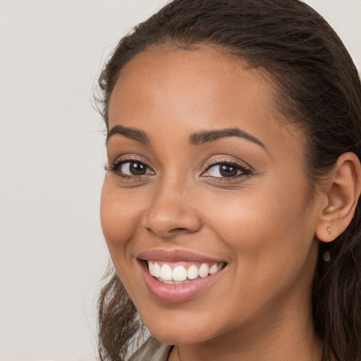 Joyful white young-adult female with long  brown hair and brown eyes