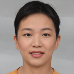 Joyful asian young-adult female with short  brown hair and brown eyes