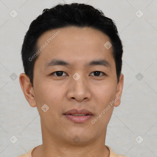 Joyful asian young-adult male with short  black hair and brown eyes