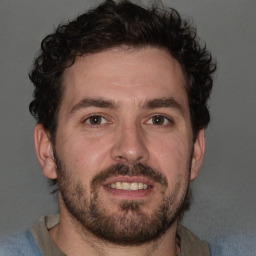 Joyful white adult male with short  brown hair and brown eyes