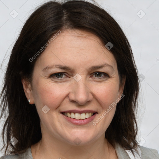 Joyful white adult female with medium  brown hair and grey eyes