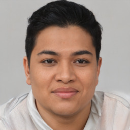 Joyful asian young-adult male with short  brown hair and brown eyes