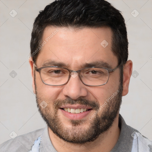 Joyful white adult male with short  black hair and brown eyes