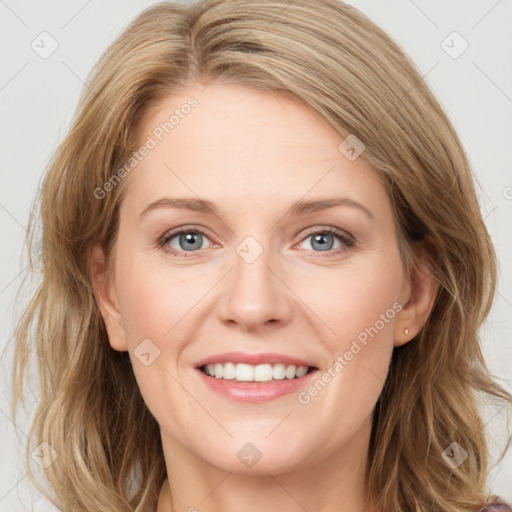 Joyful white young-adult female with long  brown hair and blue eyes