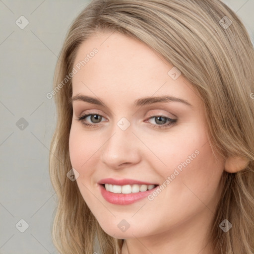 Joyful white young-adult female with long  brown hair and blue eyes