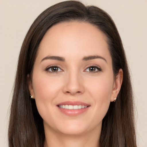 Joyful white young-adult female with long  brown hair and brown eyes