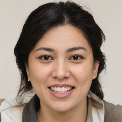 Joyful latino young-adult female with medium  brown hair and brown eyes