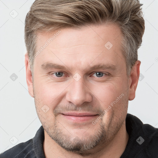 Joyful white adult male with short  brown hair and grey eyes