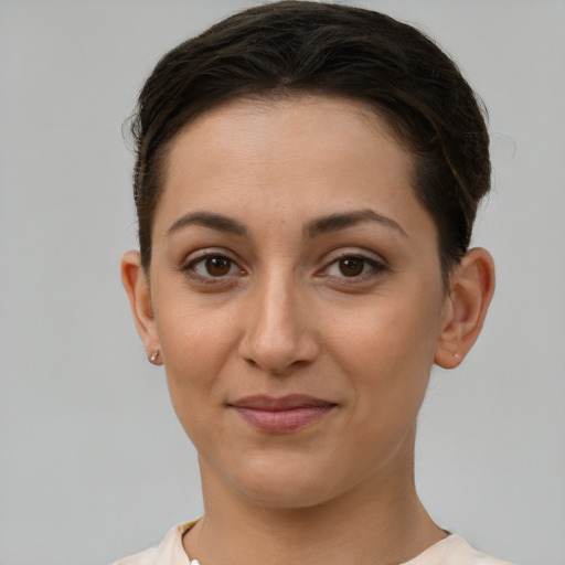 Joyful white young-adult female with short  brown hair and brown eyes