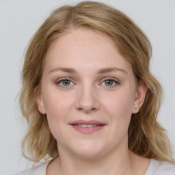 Joyful white young-adult female with medium  brown hair and blue eyes