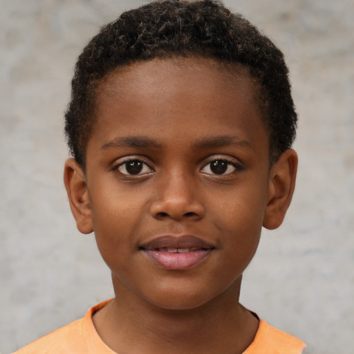 Joyful black child male with short  brown hair and brown eyes