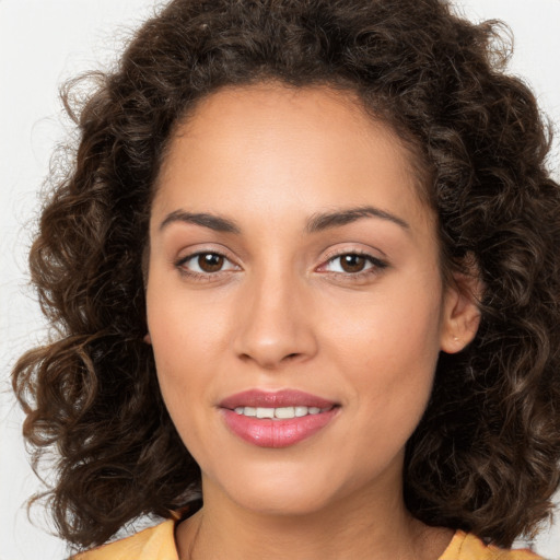 Joyful white young-adult female with long  brown hair and brown eyes