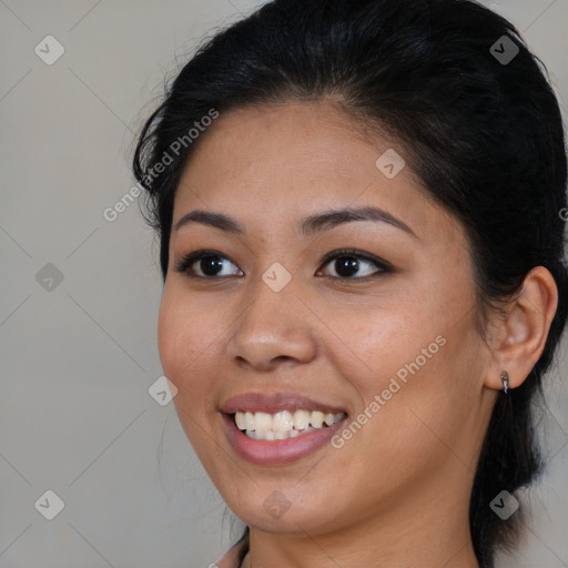 Joyful latino young-adult female with medium  brown hair and brown eyes