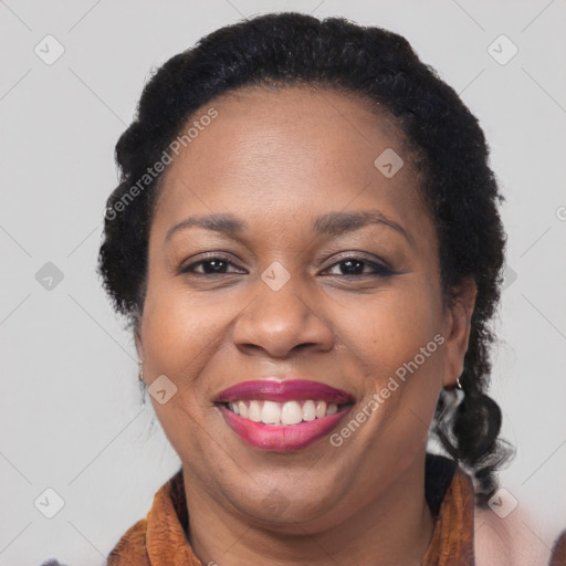 Joyful black adult female with medium  brown hair and brown eyes