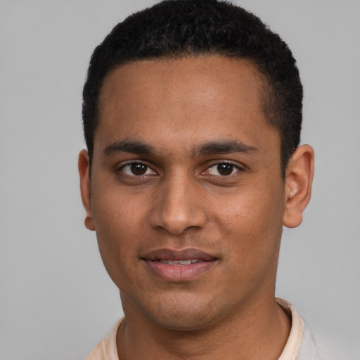 Joyful black young-adult male with short  brown hair and brown eyes